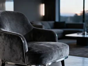Nowoczesny salon z welurowym fotelem w kolorze seledynowym, oświetlony ciepłym, porannym światłem słonecznym.